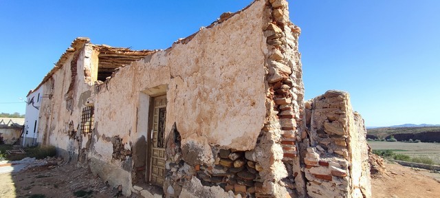 Ancient stone ruin in Rejano, Granada, showcasing historic architecture and scenic rural surrounding.