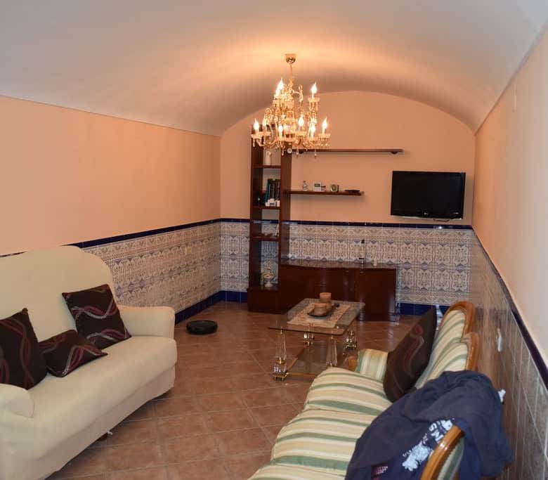 Unique cave house interior in Gorafe, Granada, featuring cozy living space with traditional decor an.