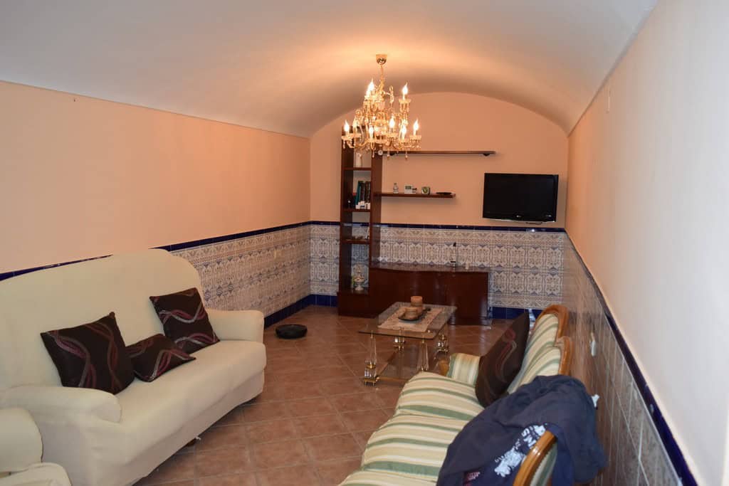 Unique cave house interior in Gorafe, Granada, featuring cozy living space with traditional decor an.