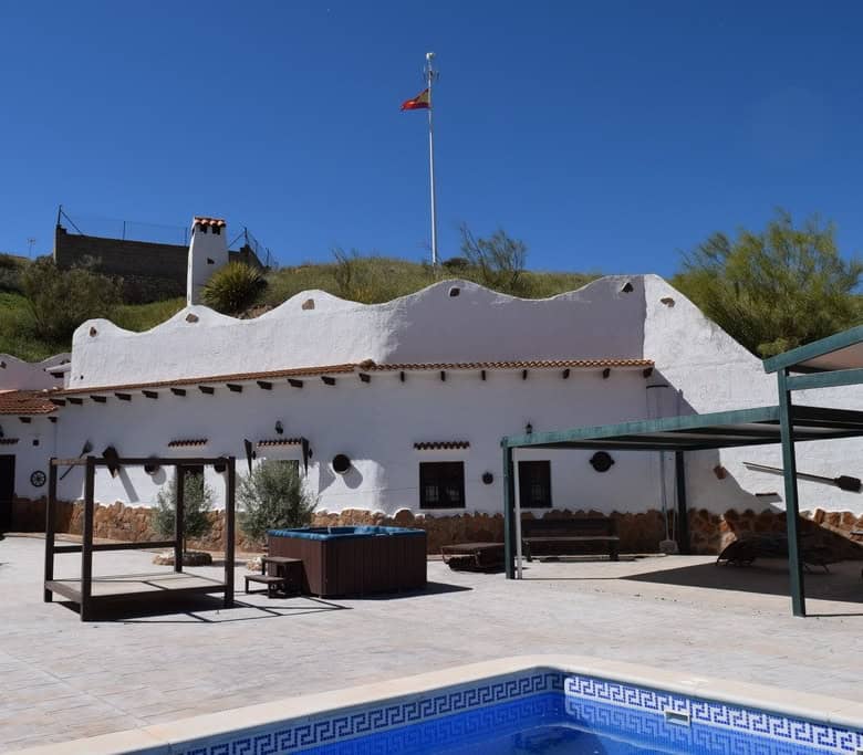 Traditional cave house with white exterior walls in Cortes de Baza, Granada.