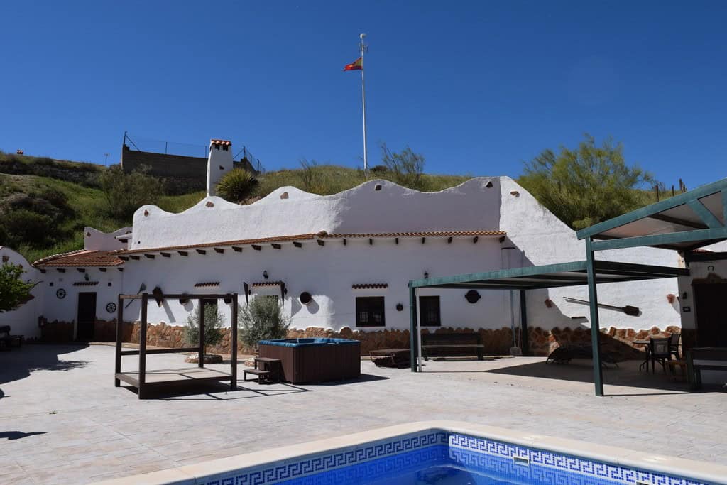 Traditional cave house with white exterior walls in Cortes de Baza, Granada.