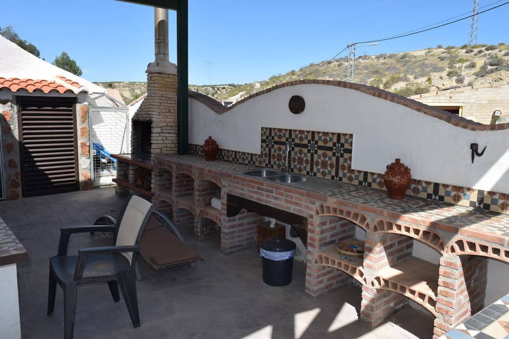 Cave house with outdoor kitchen and traditional tiled accents in Cortes de Baza, Granada. Perfect fo.