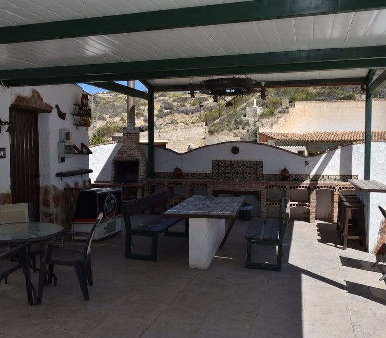 Cave house outdoor terrace with seating and traditional oven in Cortes de Baza, Granada. Unique rura.