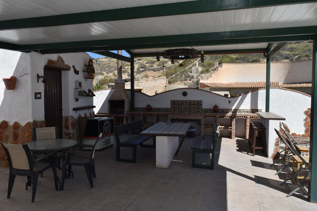 Cave house outdoor terrace with seating and traditional oven in Cortes de Baza, Granada. Unique rura.