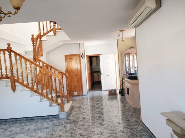 Interior view of a town house in Fines, Almeria, featuring a staircase, wooden doors, and tiled floo.