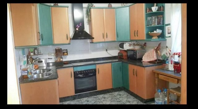 Bright kitchen in a town house located in Fines, Almeria, featuring modern cabinets and essential ap.