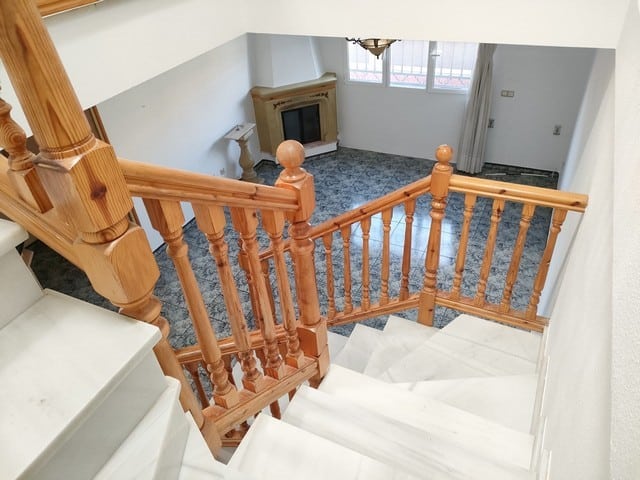 Charming town house with wooden staircase in Fines, Almeria, offering cozy living space.