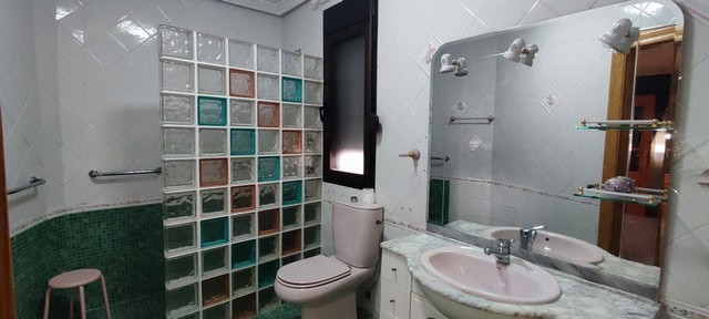 Bathroom in Tijola town house, Almeria with modern fixtures and tiled walls.