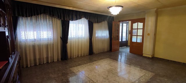 Spacious living room of a town house in Tijola, Almeria with large windows and natural light.