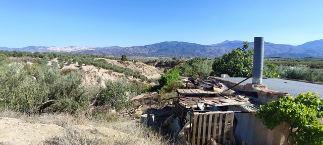 Rural property in Urracal, Almeria with scenic mountain views and traditional structures. Perfect fo.