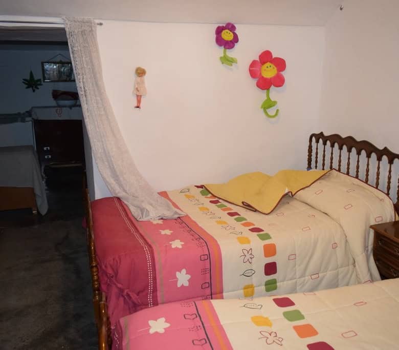 Charming cave house in Bacor, Granada, featuring rustic interiors and cozy bedrooms.