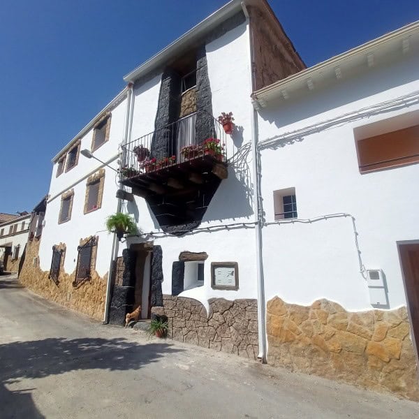 Charming village house in Fontanar, Jaen with a small balcony and traditional stone accents. Perfect.