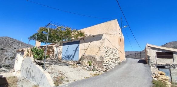 Rural property in Oria, Almeria with traditional stone walls and scenic mountain views.