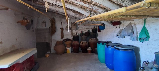 Traditional rural storage in Oria, Almeria with clay jars and water barrels.