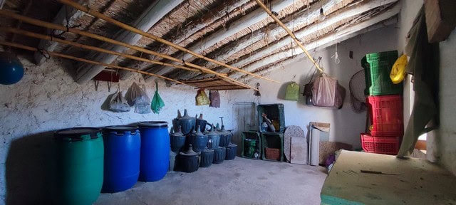 Interior of rural storage with barrels and tools in Oria, Almeria.
