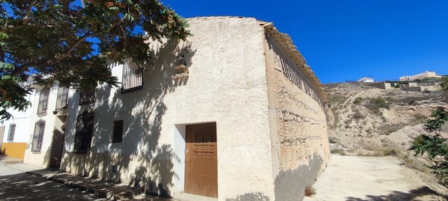 Traditional rural house in Oria, Almeria, with whitewashed walls and scenic hillside views.