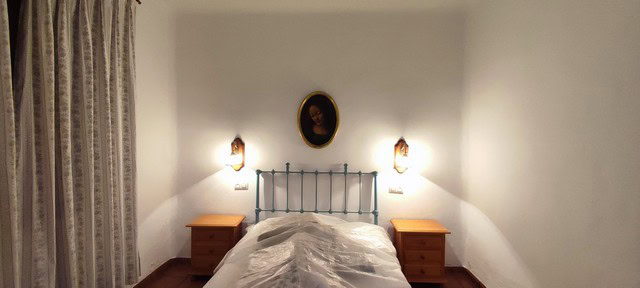 Charming bedroom in rural property in Oria, Almeria with simple decor and cozy ambiance.