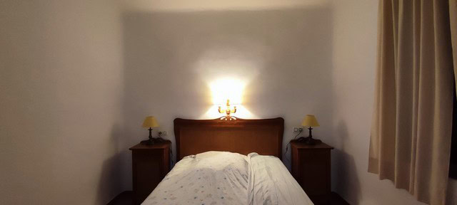 Cozy bedroom in a rural property in Oria, Almeria, featuring a double bed and warm lighting.