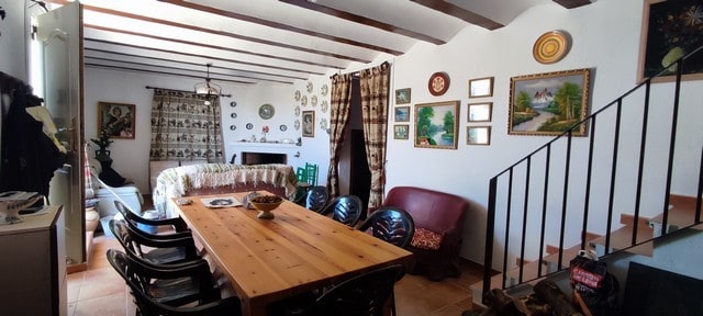 Rural property in Tijola, Almeria, featuring a cozy living and dining area with traditional decor an.