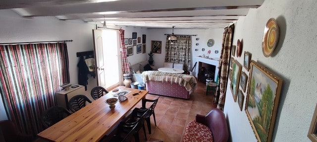 Charming rural property interior in Tijola, Almeria, featuring a cozy living and dining area with ru.