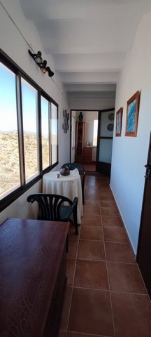 Charming rural property interior with large windows and scenic views in Tijola, Almeria.