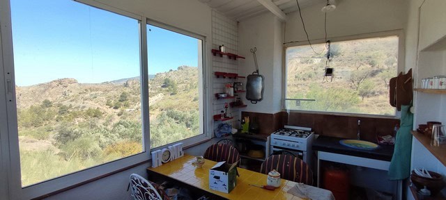 Cozy kitchen in rural Tijola with large windows showcasing scenic mountain landscapes. Perfect for e.