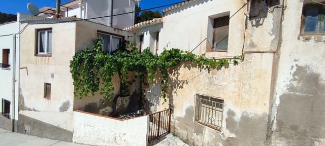 Charming village property in Bayarque, Almeria with traditional architecture and lush greenery.