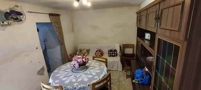 Cozy village home interior with dining area and simple furnishings in Bayarque, Almeria.