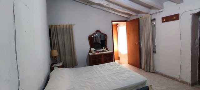 Bright bedroom with traditional rustic decor in Bayarque village, Almeria.