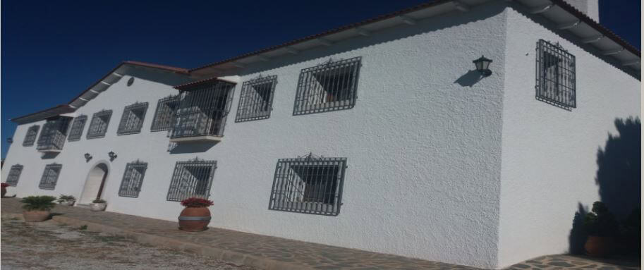 Commercial property for sale in Oria, Almeria, featuring traditional architecture and secure window.