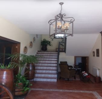 Interior view of a spacious commercial property in Oria, Almeria, featuring a staircase, seating are.
