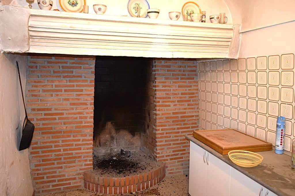 Traditional cave house fireplace in El Margen, Granada, with brick construction and rustic charm.