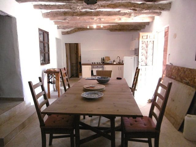 Charming interior of a rural property in Hijate, Almeria, featuring a rustic dining area with wooden.