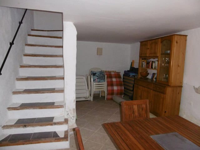 Charming rustic interior of a rural property in Hijate, Almeria, featuring wooden furniture and cozy.