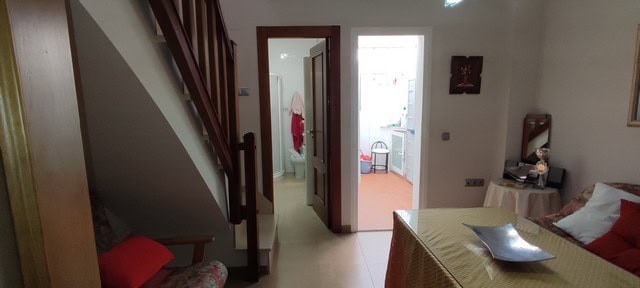 Cozy interior of a town house in Tijola, Almeria, featuring a living room with staircase and a view.