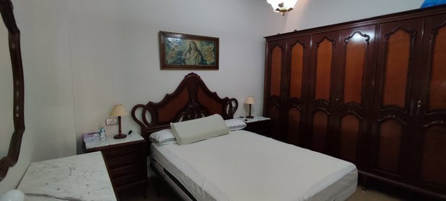 Traditional bedroom with wooden furniture in Tijola town house, Almeria, Spain.