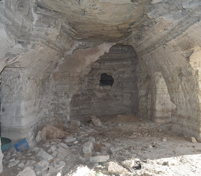 Ancient cave house interior in Benamaurel, Granada, showcasing natural rock walls and rustic charm.
