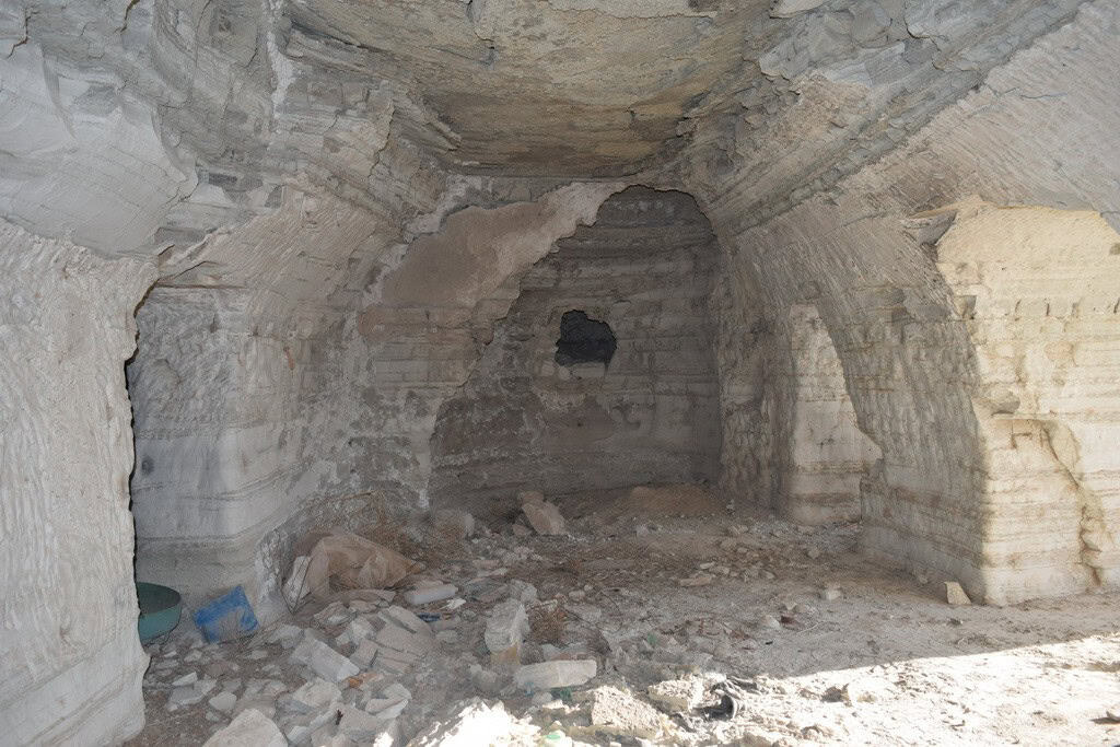 Ancient cave house interior in Benamaurel, Granada, showcasing natural rock walls and rustic charm.