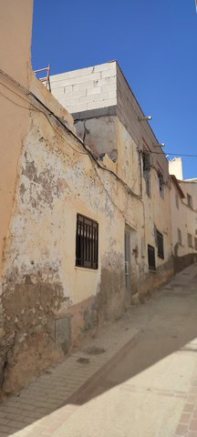 Traditional town house in Tijola, Almeria with rustic exterior and narrow street setting.