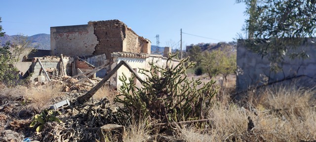 Rural property in Olula del Rio, Almeria with traditional stone buildings and dry landscape.