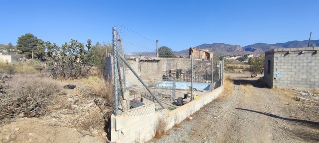 Fenced rural property with open land and mountain views in Olula del Rio, Almeria.