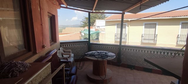 Balcony view of a town house in Tijola, Almeria with outdoor seating and scenic surroundings.