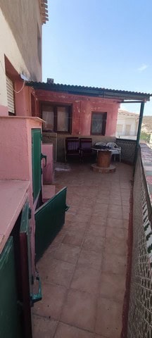 Charming town house in Tijola, Almeria, featuring a cozy outdoor terrace with seating and a barbecue.
