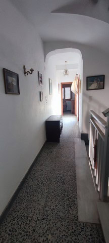 Charming hallway of a town house in Tijola, Almeria, showcasing traditional architecture and cozy li.