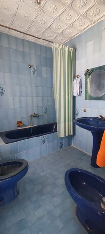 Town House Bathroom with Blue Tiles and Vintage Fixtures.