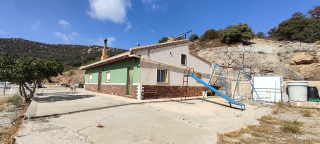 Rural property in Sierro, Almeria with outdoor playground and scenic mountain views.