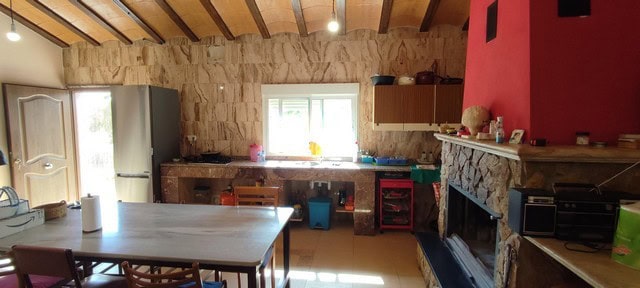 Bright rural kitchen with stone walls and modern appliances in Sierro, Almeria.
