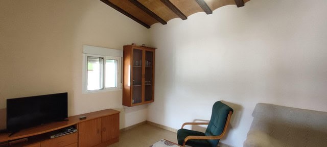 Cozy interior of a rural property in Sierro, Almeria, featuring a simple living room with a TV, wind.