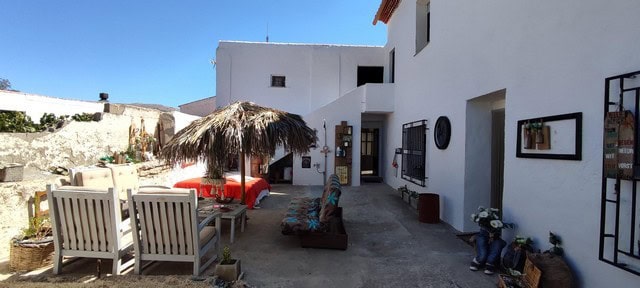 Charming village property in Las Vertientes, Granada with outdoor seating and traditional whitewashe.