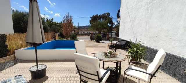 Beautiful outdoor patio with pool and seating area in Las Vertientes, Granada.